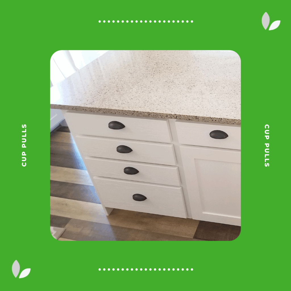 Brushed bronze cup pulls on white drawers, adding a traditional and vintage-inspired touch to a classic kitchen.