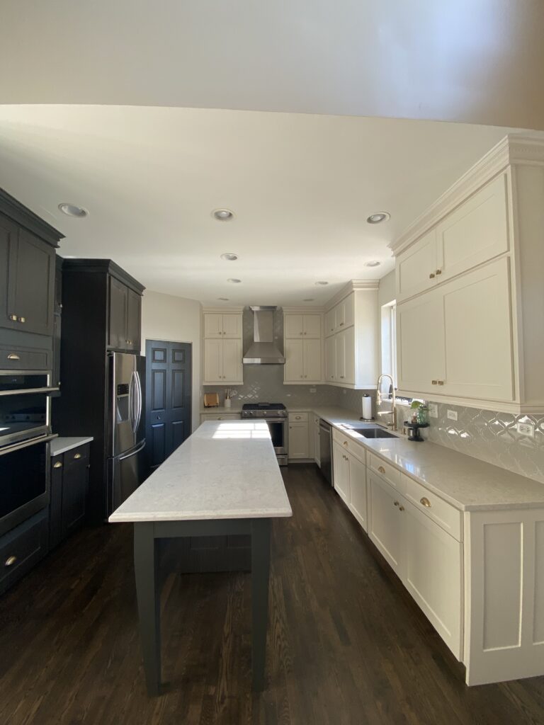 Antique White kitchen cabinets with quartz countertops and subway tile backsplash