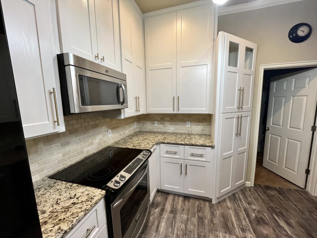 Refreshed kitchen with brand new white Shaker cabinet doors and drawer fronts on the original cabinet boxes