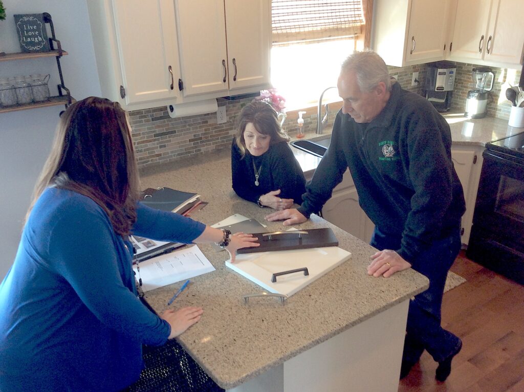 Kitchen Refresh design consultant presenting cabinet door samples during a free in-home consultation