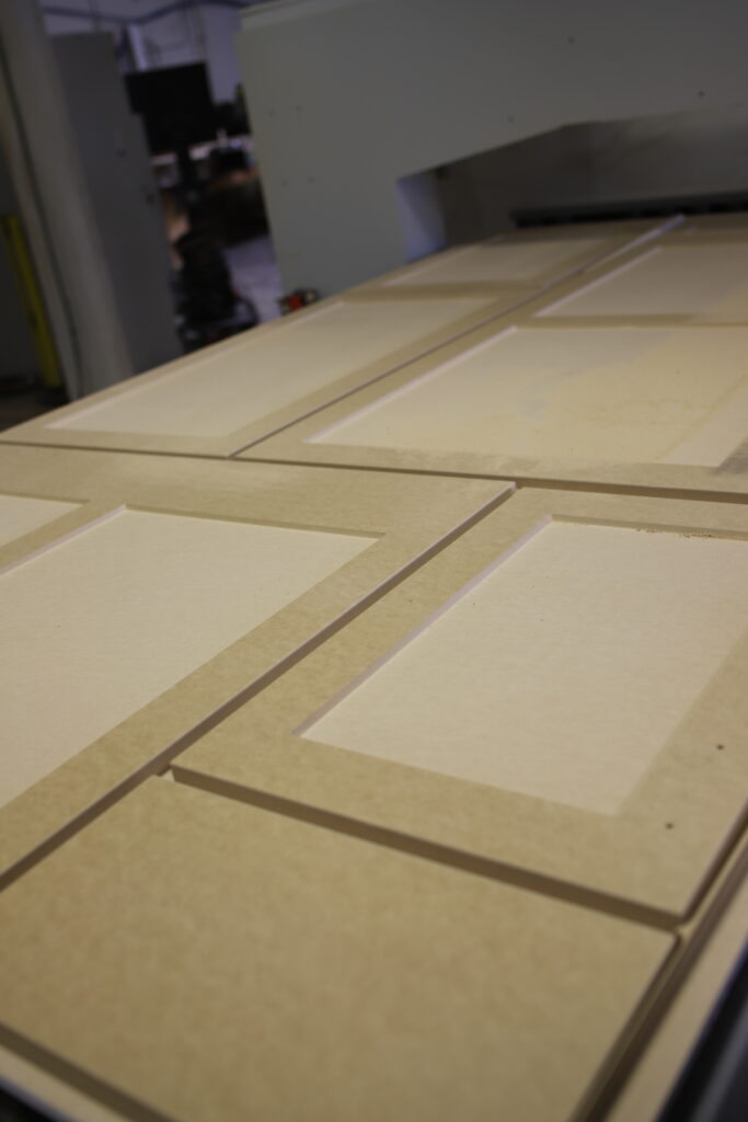 Custom cabinet doors with raised panel construction in production at Kitchen Refresh's North Dakota facility
