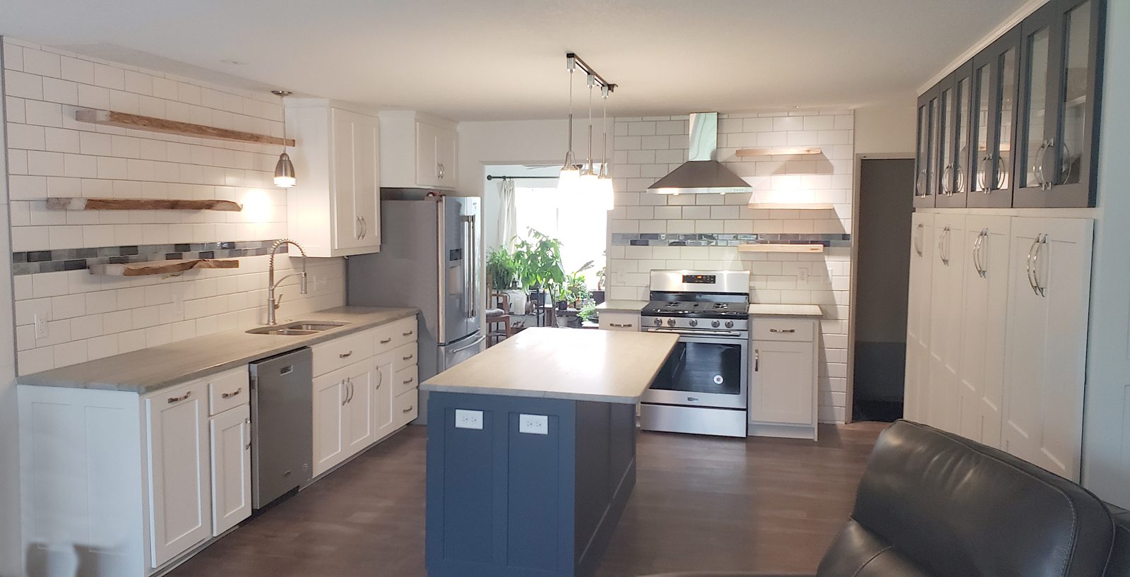Finished kitchen with new white thermofoil cabinet doors and a navy island, no cabinet tear-out needed