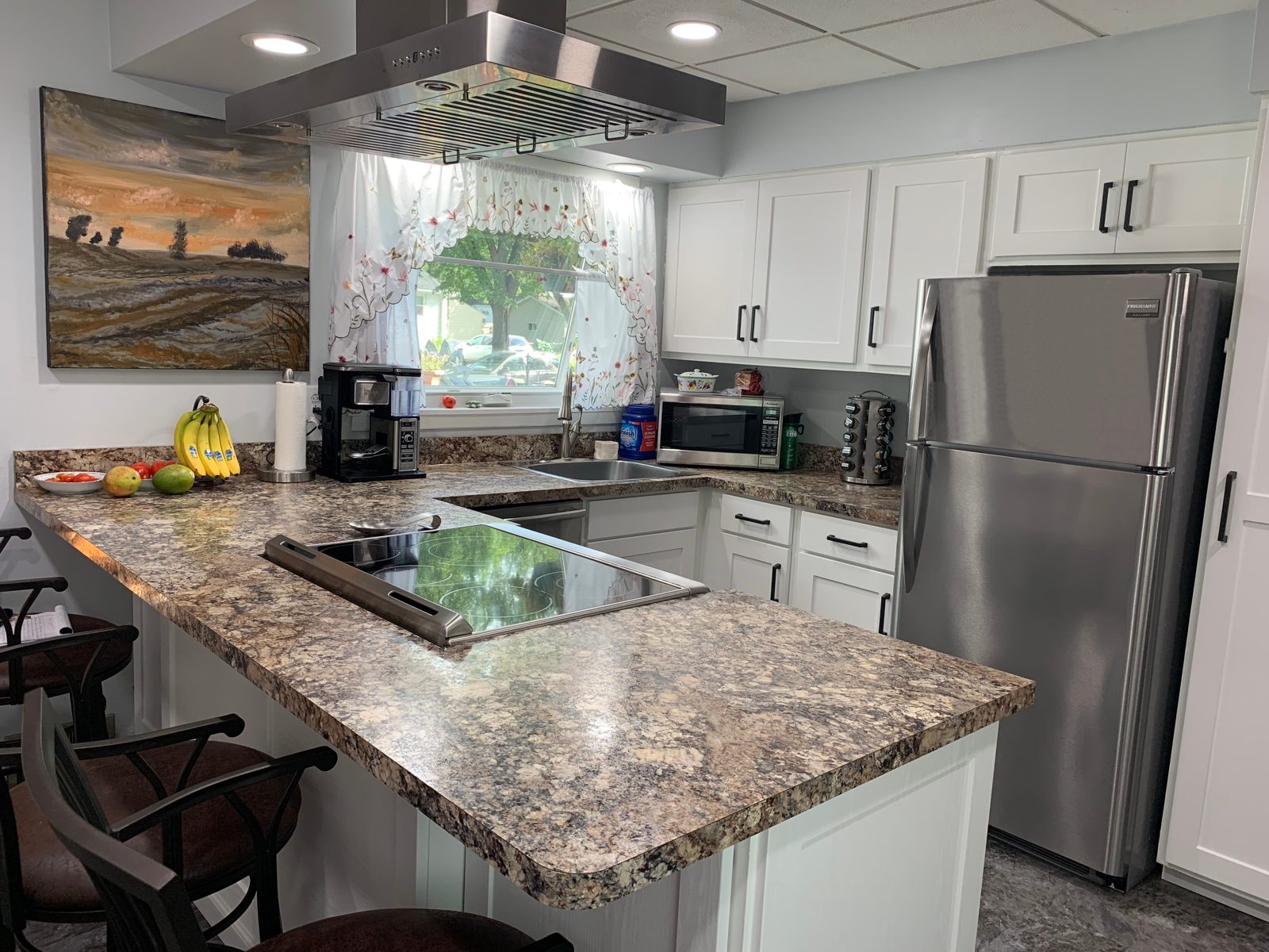 White shaker thermofoil kitchen cabinets after a Kitchen Refresh cabinet door replacement